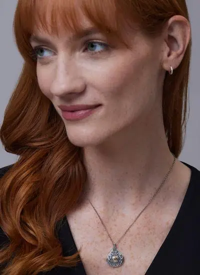 Red haired model wearing Wood Quay Teardrop Pendant with 18K Gold Bead
